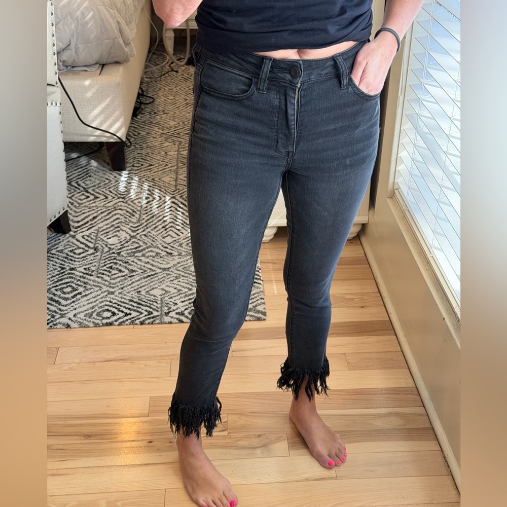 American Eagle Outfitters high-rise jegging crop fringe distressed black jeans.